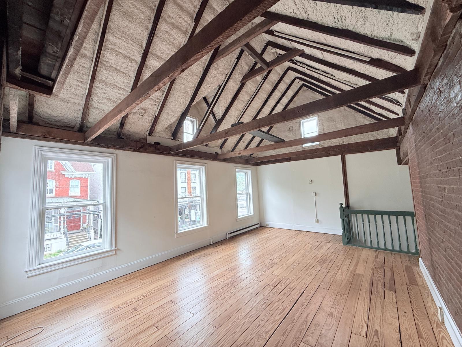 Great Hall showing full length of room with vaulted ceiling and natural light from end windows.